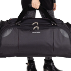 Person holding a black duffel bag with 'Pierre Cardin' branding on a white background