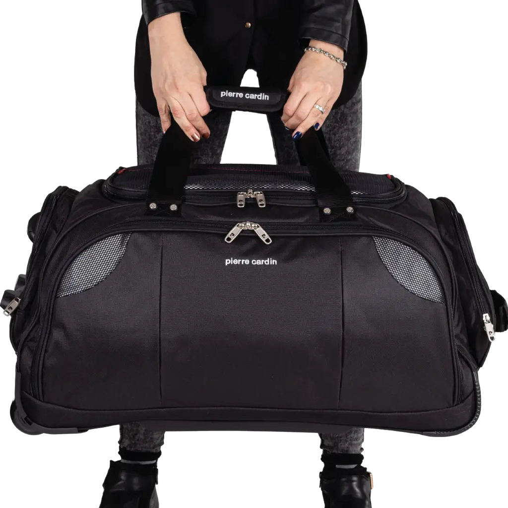 Black duffel bag with 'Pierre Cardin' branding held by a person on a white background