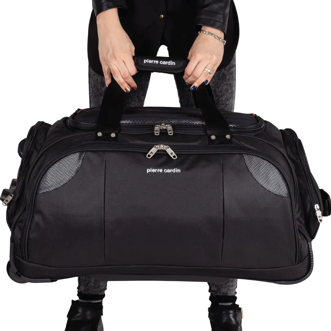 Black duffel bag with 'Pierre Cardin' branding held by a person on a white background