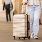 Person pulling a beige suitcase with a blurred background