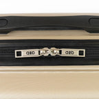 Close-up of a beige suitcase with a black handle and visible brand logo.
