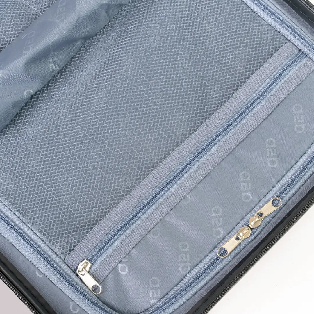 Close-up of a suitcase with zippers and mesh pocket on a white background