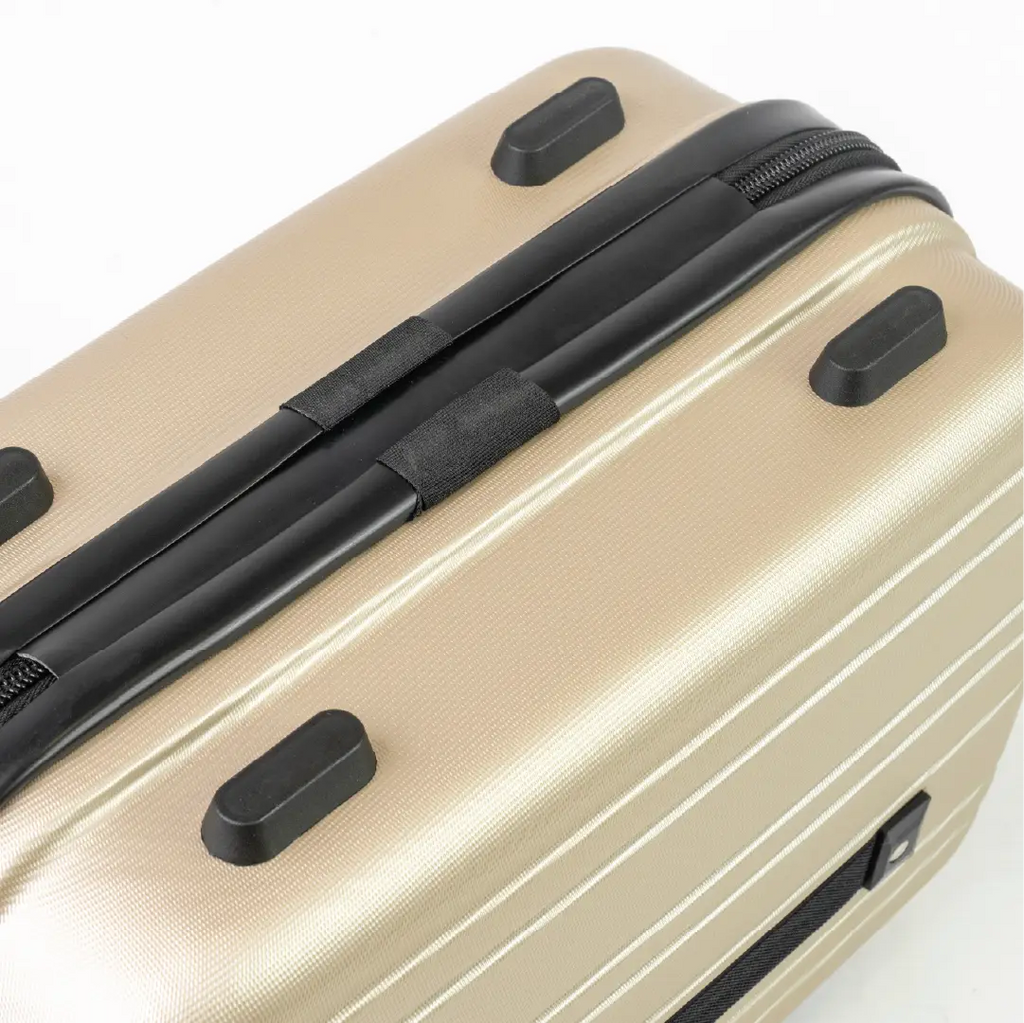 Beige suitcase with black handle and wheels on a white background