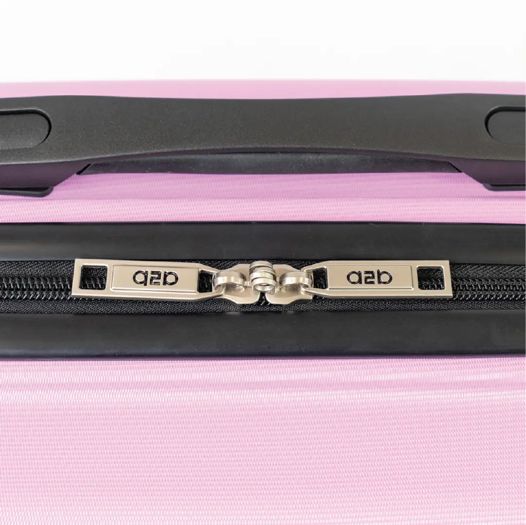 Close-up of a pink suitcase with a black handle and zipper, featuring the brand.