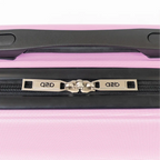 Close-up of a pink suitcase with a black handle and zipper, featuring the brand.