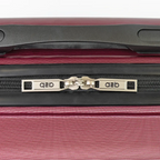 Close-up of a red suitcase zipper with branding on a white background