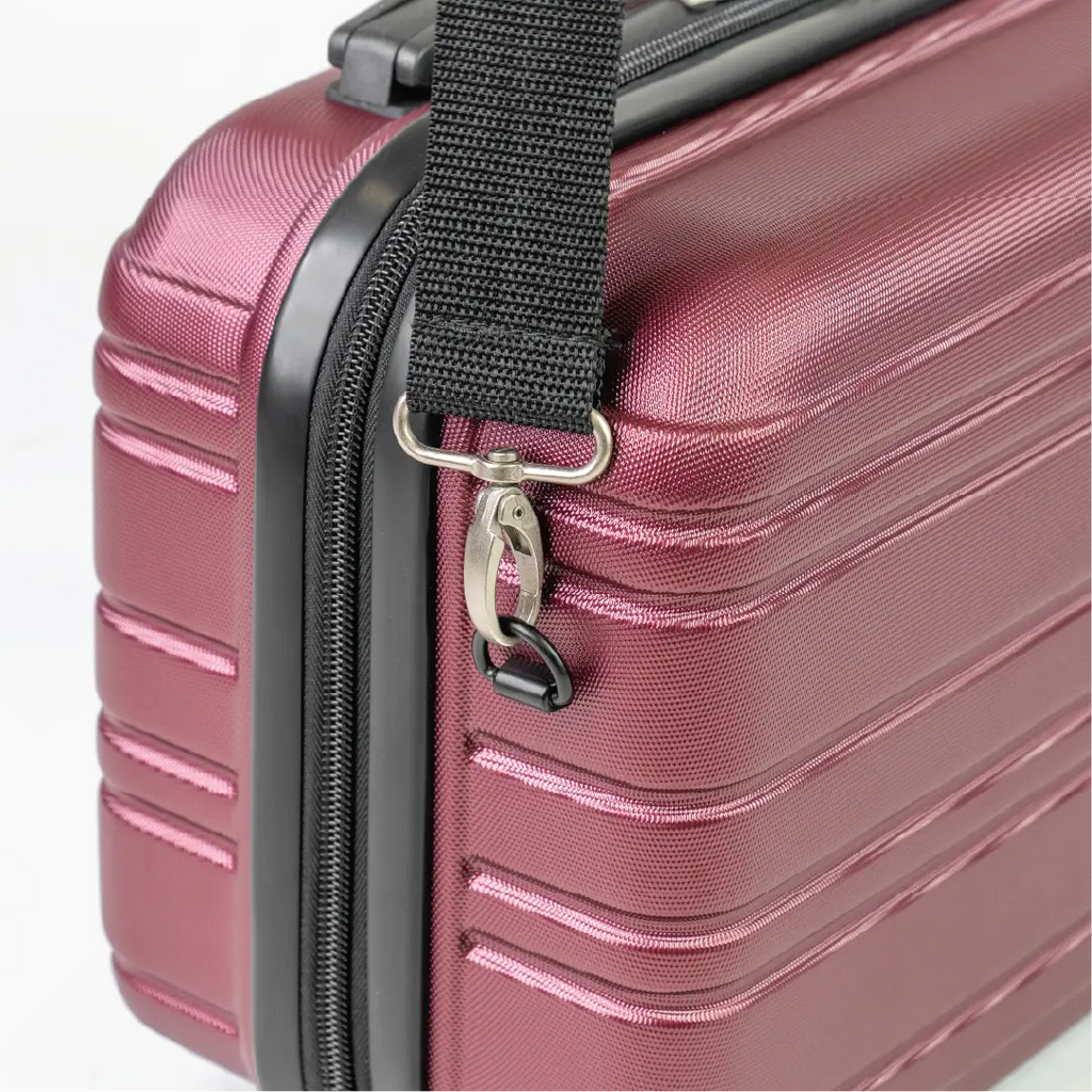 Close-up of a red suitcase with a black handle and strap on a white background