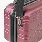 Close-up of a red suitcase with a black handle and strap on a white background