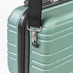 Close-up of a green suitcase with a black handle strap and zipper.