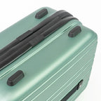 Green suitcase with black handle and wheels on a white background