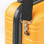 Close-up of a yellow suitcase with a black strap and zipper
