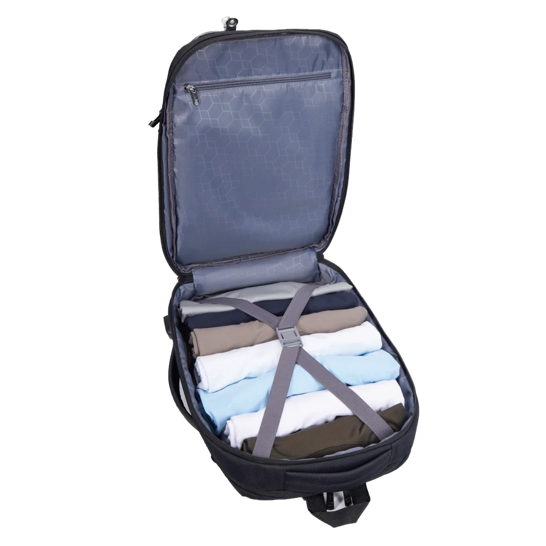 Open suitcase with folded clothes and straps on a white background