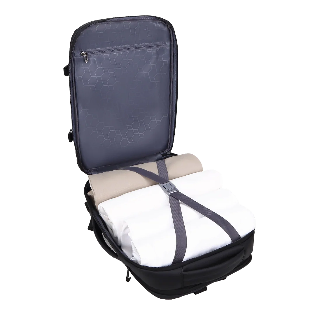 Open backpack with folded clothes inside on a white background