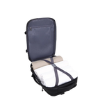 Backpack with folded clothes inside on a white background