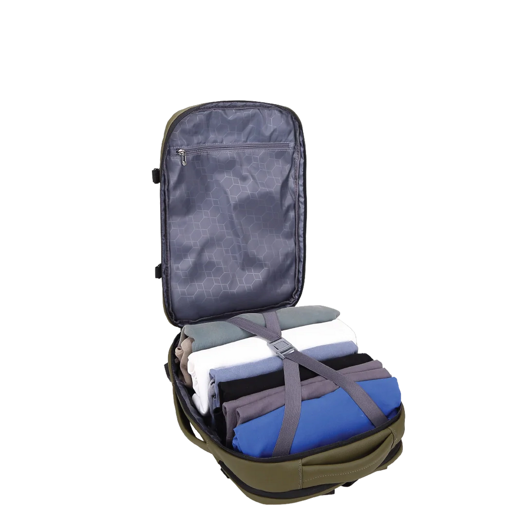 Backpack opened and filled with clothes secured by a strap.