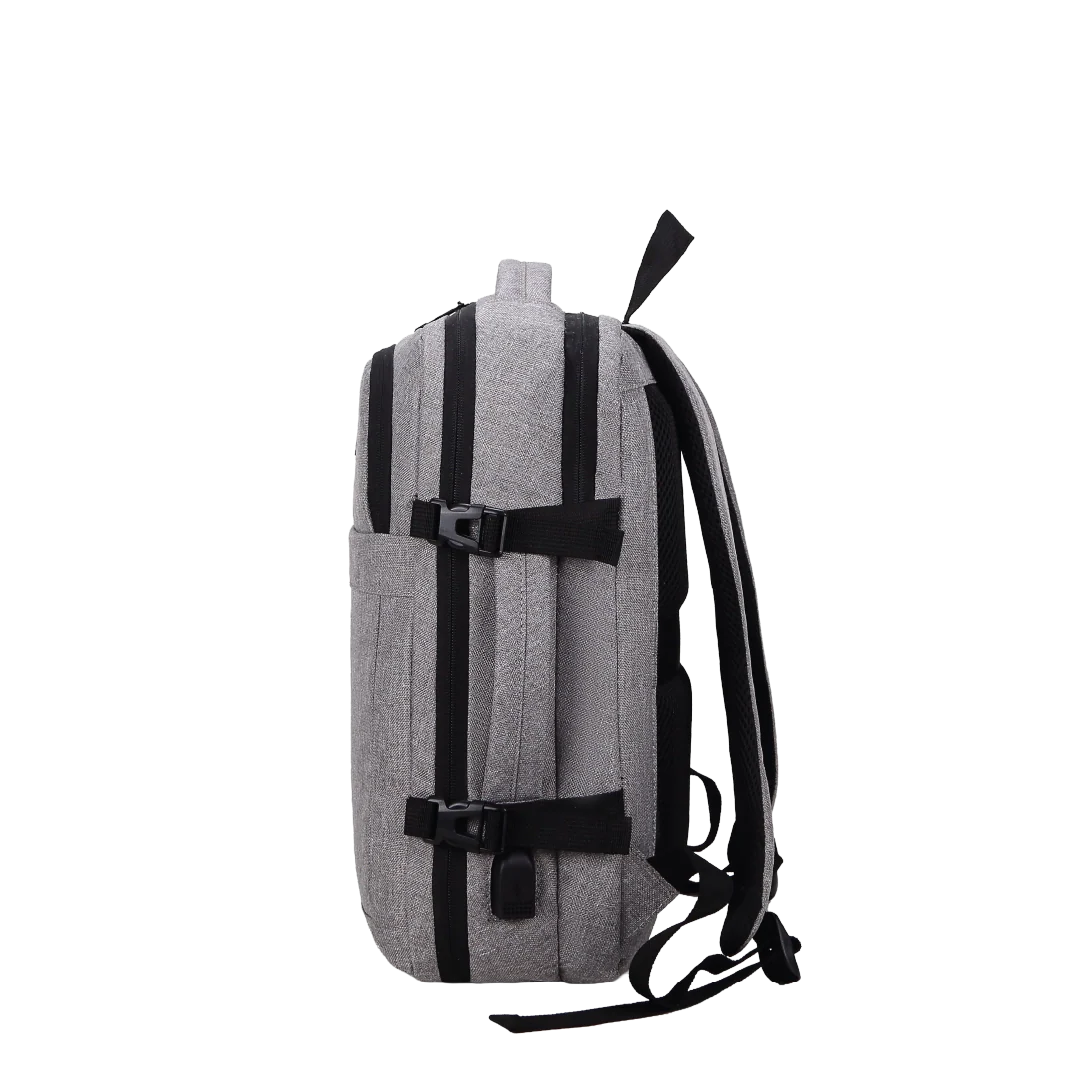 Sideview of a grey backpack with straps and a handle.