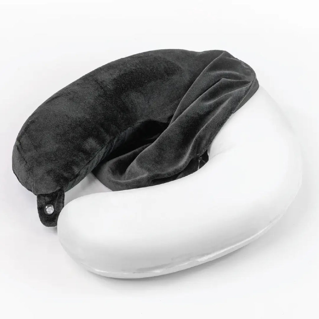 Gray travel pillow on a white surface