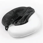 Gray travel pillow on a white surface