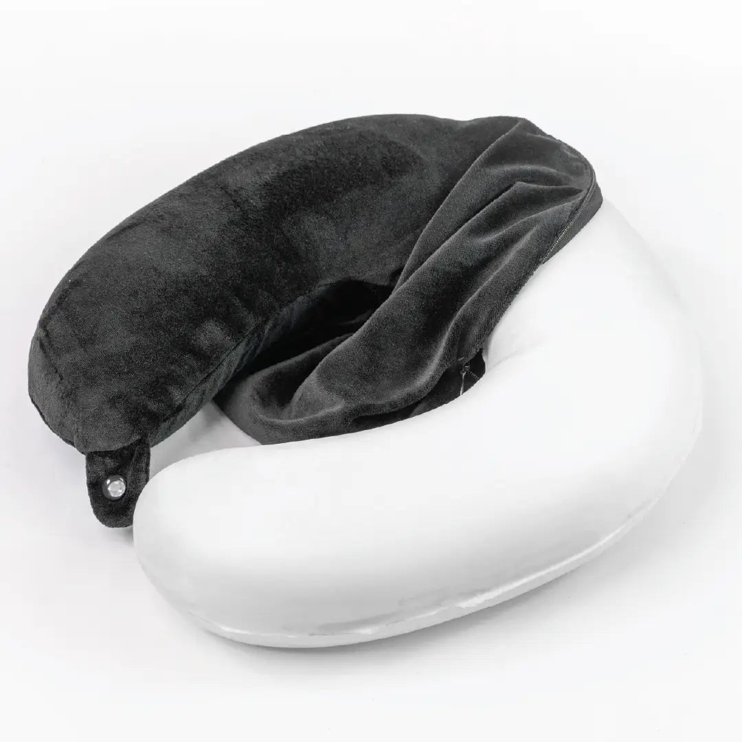 Gray travel pillow on a white surface