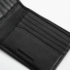Close-up of a black leather wallet with visible stitching on a white background