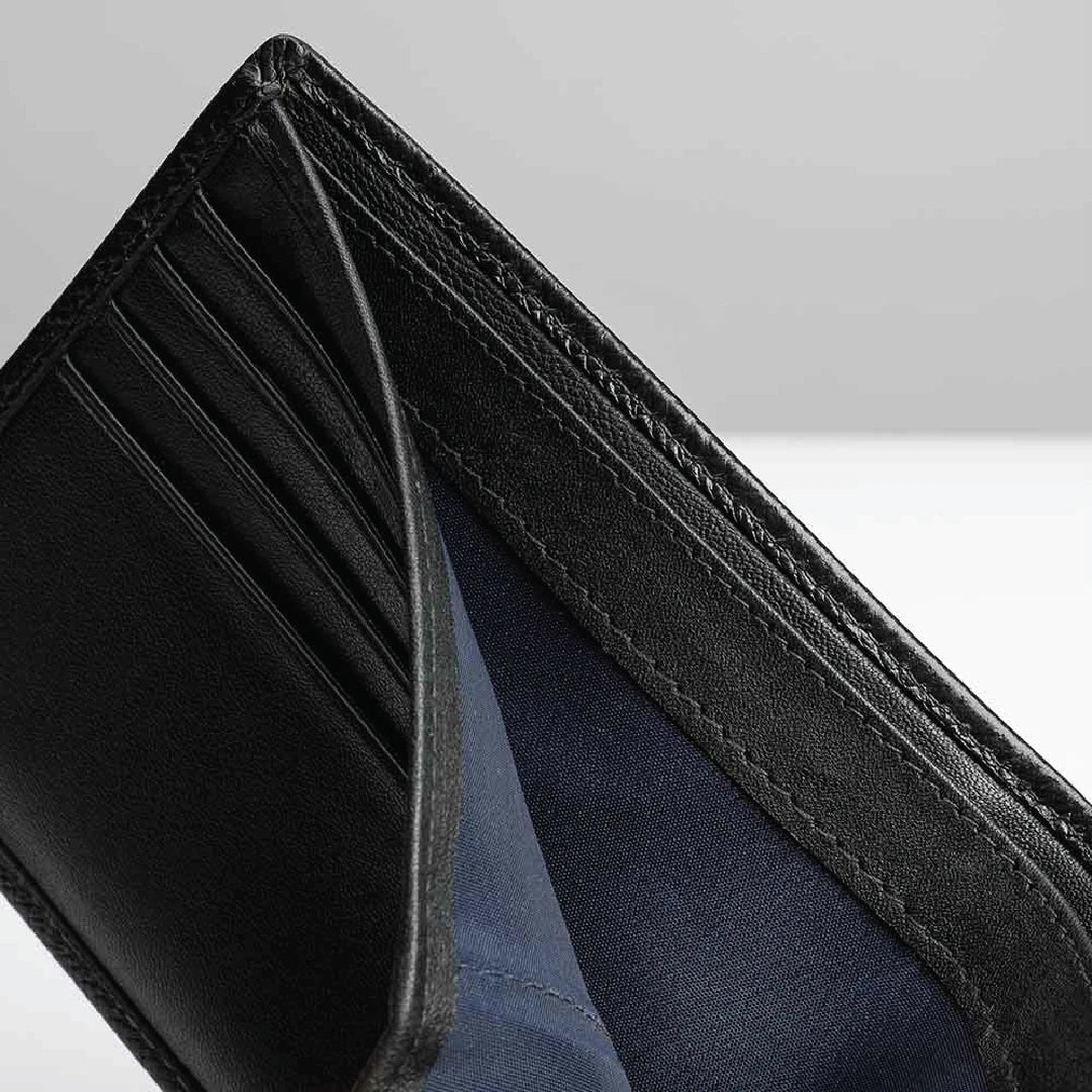 Close-up of a black leather wallet with blue lining on a light gray background