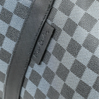 Close-up of a textured gray fabric with a brand logo.