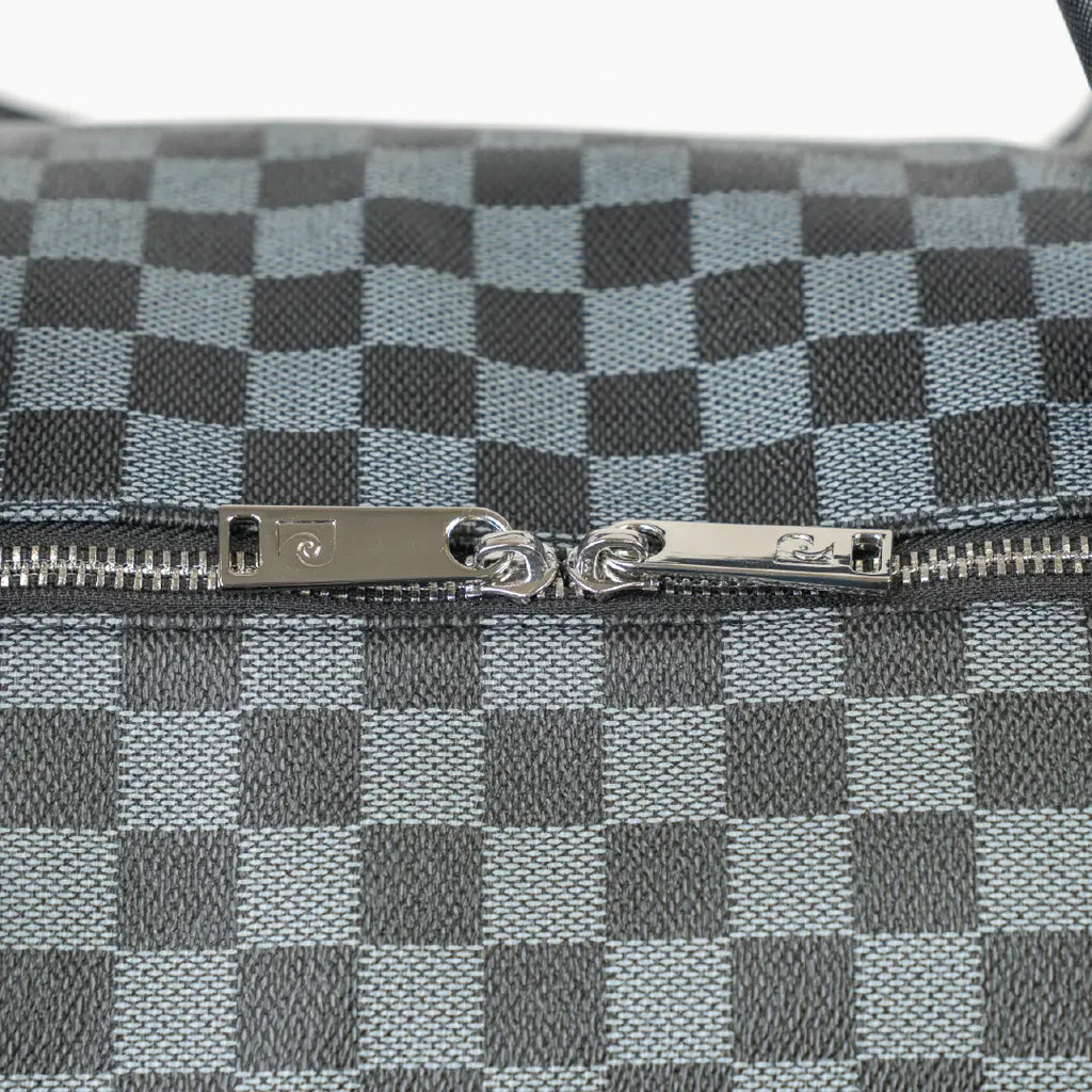 Close-up of a checkered pattern with a zipper on a gray background