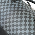 Close-up of a gray and black checkered bag with a blurred background