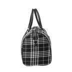 Black and white checkered handbag with leather handles on a white background