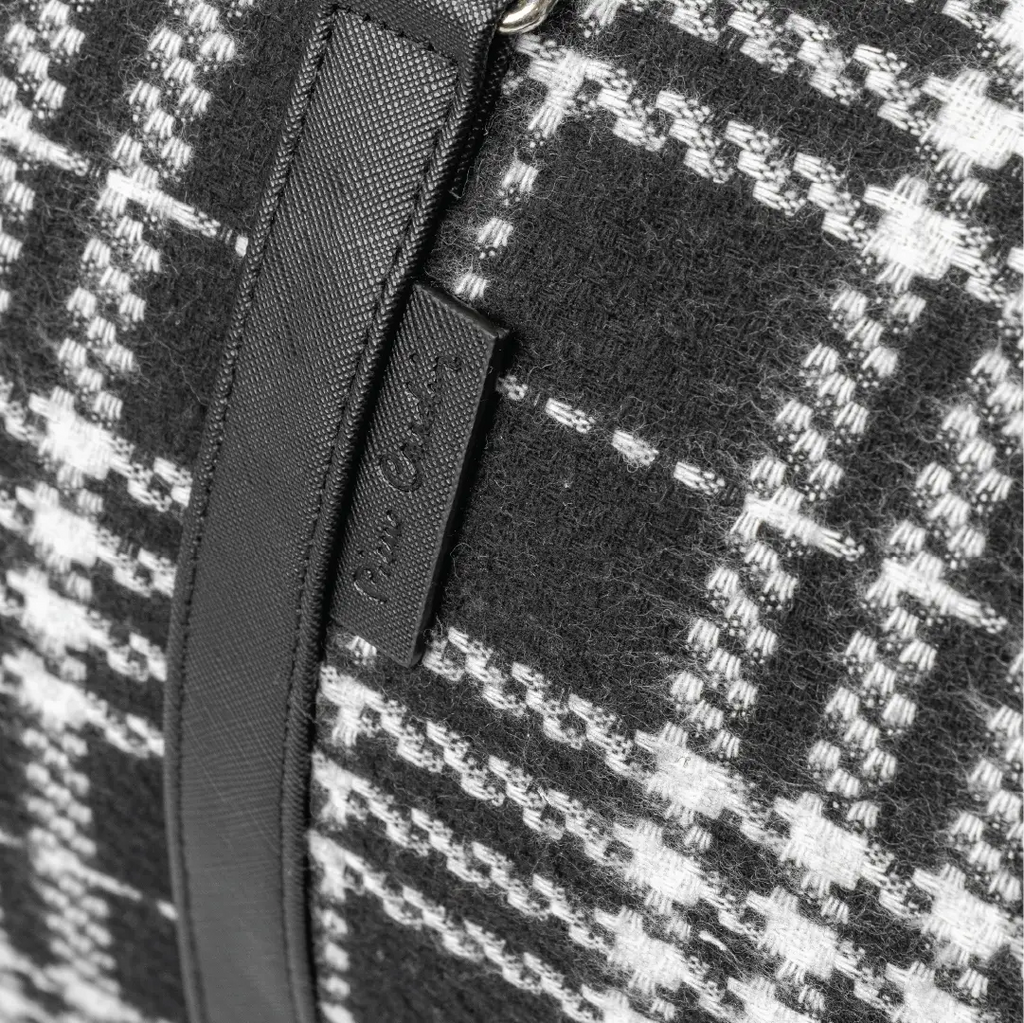 Close-up of a black and white checkered fabric with a zipper detail.