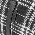 Close-up of a black and white checkered fabric with a zipper detail.