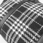 Close-up of a black and white checkered fabric with a strap
