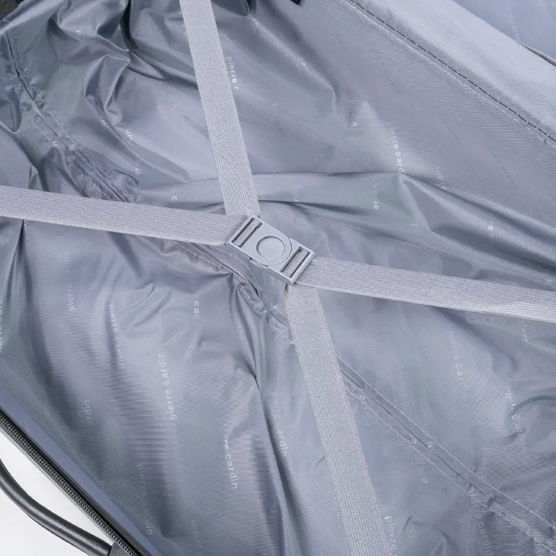 Close-up of a gray suitcase with straps and zippers.