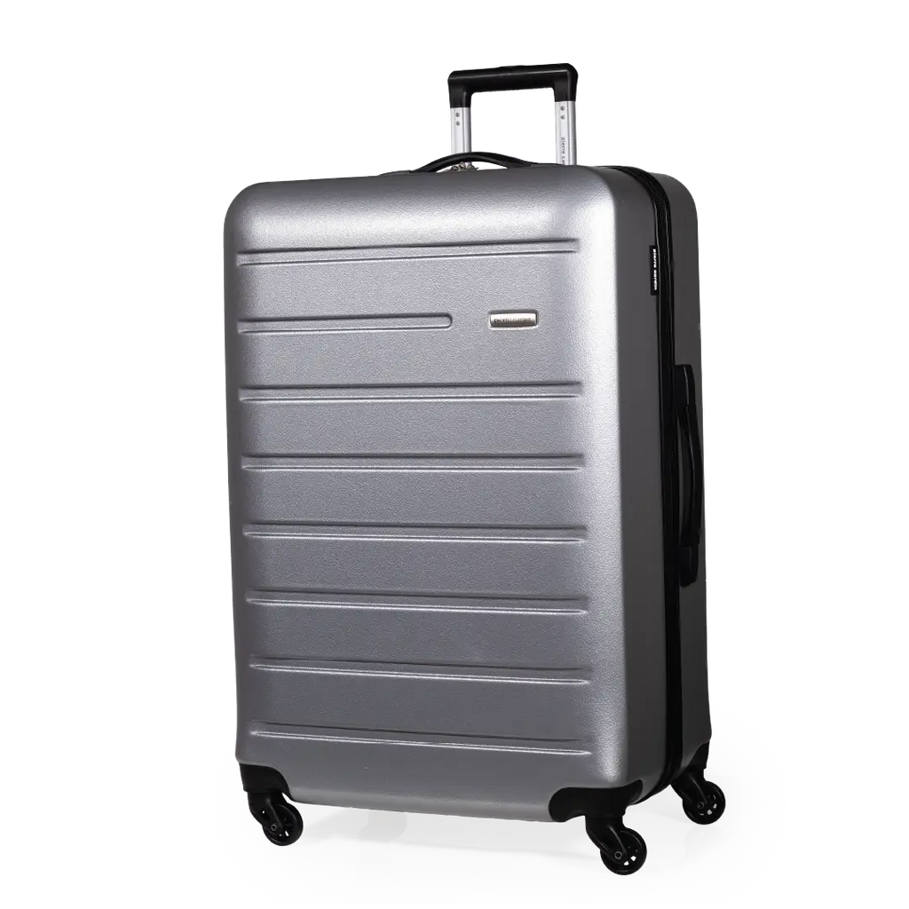 Silver suitcase with black handle and wheels on a white background