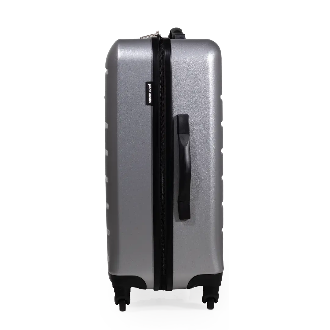 Silver suitcase with black handle and wheels on a white background