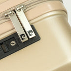Close-up of a beige suitcase with a silver zipper and black handle.