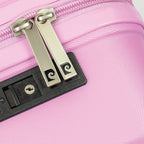 Close-up of a pink suitcase with a silver lock mechanism.