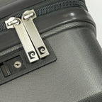 Close-up of a silver lock on a gray suitcase