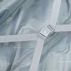 Close-up of a gray fabric with a metal clip on a gray background
