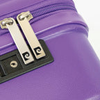 Close-up of a purple suitcase with a silver zipper and black handle.