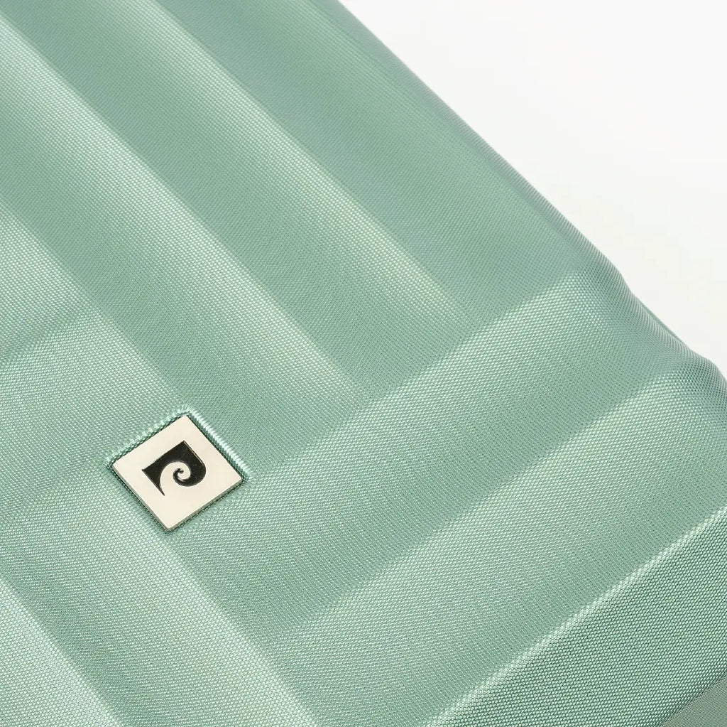 Close-up of a light green fabric with a small logo on a white background