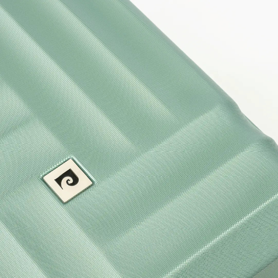 Close-up of a light green fabric with a small logo on a white background