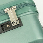 Close-up of a green suitcase with a zipper and lock mechanism.