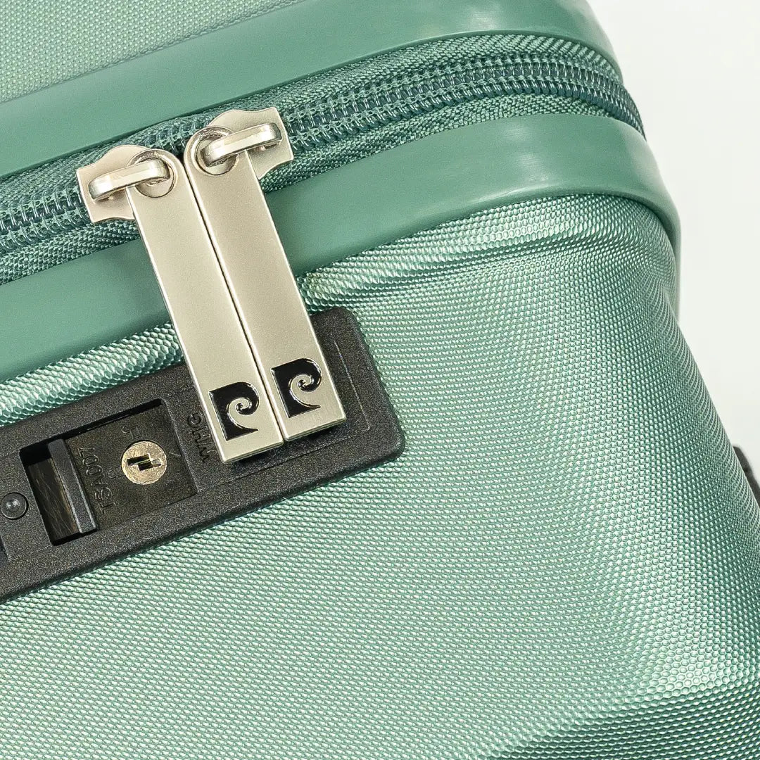 Close-up of a green suitcase with a zipper and lock mechanism.