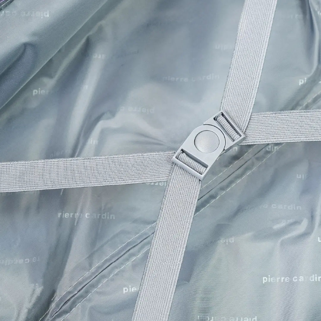 Open suitcase with gray straps on a textured fabric background