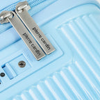 Close-up of the locking mechanism on a light blue suitcase