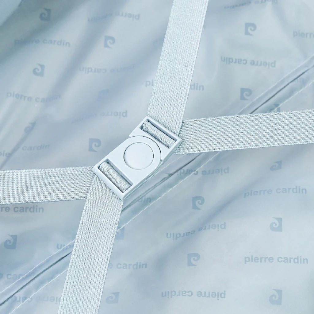 Suticase interior with a strap, buckle and brand logo.