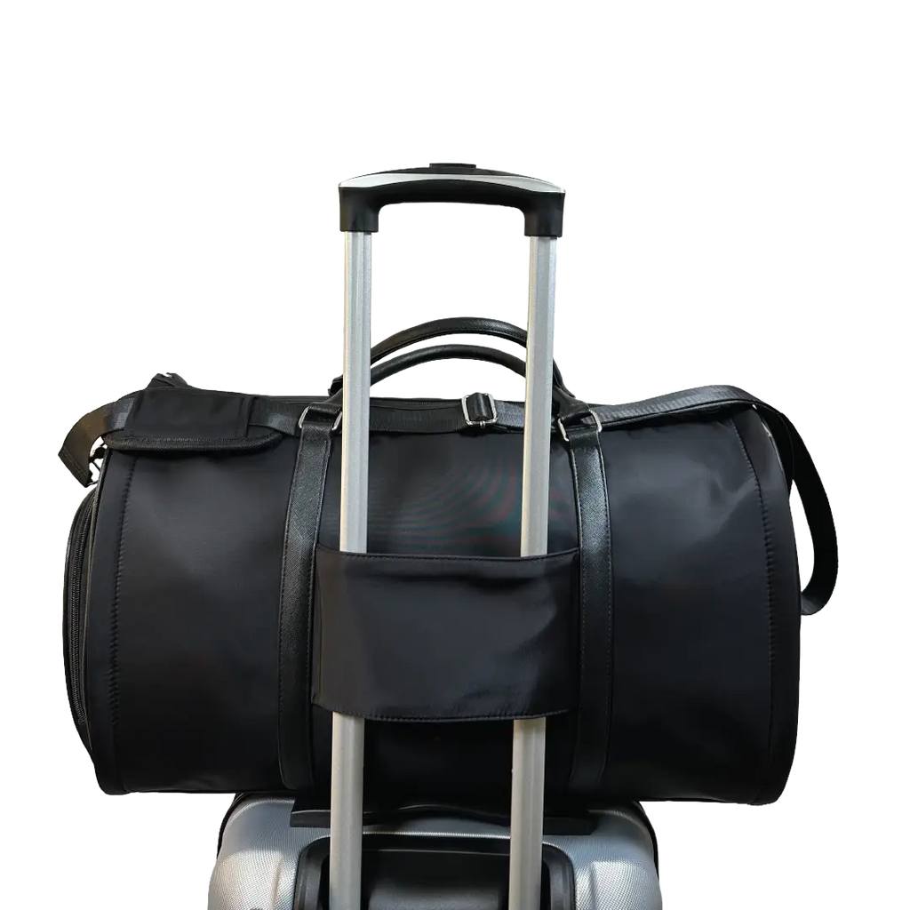 Black duffel bag on a suitcase on a white background
