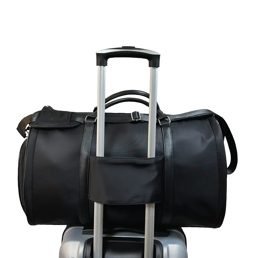 Black duffel bag on a suitcase on a white background