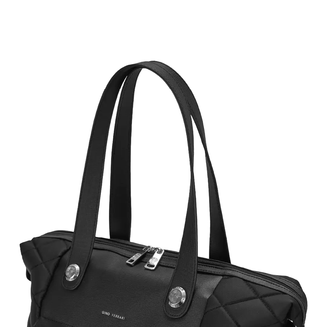 Black handbag with silver zippers on a white background